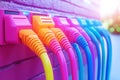 Row of colorful Ethernet cables plugged into wall sockets symbolizing home and office network connections and flexible internet