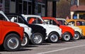 A row of colorful Fiat 500s in a roadside parking lot Royalty Free Stock Photo