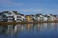 Row of Colorful Houses Reflecting in a Pond in a Surban Neighborhood. Royalty Free Stock Photo