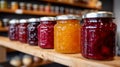 Row of colorful jam jars on a wooden shelf. Royalty Free Stock Photo