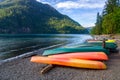 Row Of Colorful Kayaks Lying On The Shore Of Lake Crescent