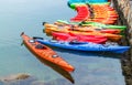 Row of colorful kayaks for rent in the water Royalty Free Stock Photo