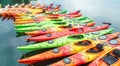 Row of colorful kayaks for rent in the water