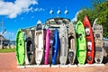 A row of colorful kayaks standing upright against a building at a marina in Islamorada, Florida