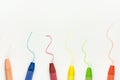 Row of Colorful Multicolored Pastel Wax Crayons on White Paper with Hand Drawn Scribbles. Back to School Kids Arts Creativity Royalty Free Stock Photo