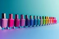 A row of colorful nail polish bottles lined up on a blue surface Royalty Free Stock Photo