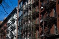 Row of Colorful Old Brick Apartment Buildings with Fire Escapes in Nolita of New York City