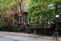 Row of Colorful Old Brick Residential Buildings along an Empty Street and Sidewalk in Greenwich Village of New York City Royalty Free Stock Photo