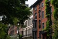 Row of Colorful Old Brick Residential Buildings in Greenwich Village with Green Trees in New York City Royalty Free Stock Photo