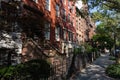 Row of Colorful Old Brick Residential Buildings in the West Village of Greenwich Village in New York City along the Sidewalk Royalty Free Stock Photo