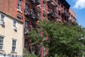 Row of Colorful Old Brick Residential Buildings with Fire Escapes in Greenwich Village in New York City Royalty Free Stock Photo