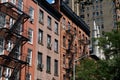 Row of Colorful Old Brick Residential Buildings with Fire Escapes in Greenwich Village in New York City Royalty Free Stock Photo