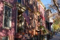 Row of Colorful Old Homes in Greenpoint Brooklyn New York with an American Flag and Sidewalk Royalty Free Stock Photo