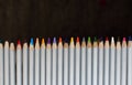 Row of colorful pencils on black background. Drawing concept. Isolated crayons. Rainbow of colored pencils. Pencils closeup. Royalty Free Stock Photo