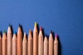 Row of colorful pencils on blue background Royalty Free Stock Photo