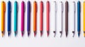 row of colorful pens against a white background