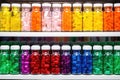 a row of colorful pill bottles on a pharmacy shelf Royalty Free Stock Photo