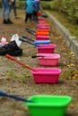 Row of colorful plastic basins with soup solution for making soap bubbles. Nursery playground Royalty Free Stock Photo