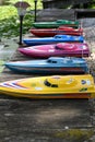 Row of Colorful remote control boats batteries along lake shore, prior to a boat race