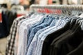 A row of colorful row t-shirts hanging on hangers in t-shirts re Royalty Free Stock Photo