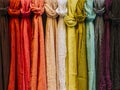 Row of colorful scarves hanging in a market