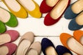 Row of colorful shoes ballerinas on a white wooden background. Royalty Free Stock Photo