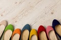 Row of colorful shoes ballerinas on a white wooden background. Royalty Free Stock Photo