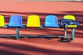 Row of colorful stadium seats and sportsman`s clothes