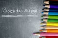 Row of colorful stationery of pencils for drawing on blackboard with Back to School message