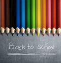 Row of colorful stationery of pencils for drawing on blackboard with Back to School message