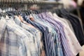 A row of colorful row t-shirts hanging on hangers in t-shirts re Royalty Free Stock Photo