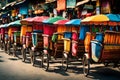 A row of colorful, traditional rickshaws lined up on a bustling street in an Asian market