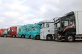 Row of Colorful Trailer Trucks on a Yard