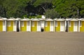 Row of colourful beach huts on a sandy beach Royalty Free Stock Photo