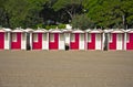 Row of colourful beach huts on a sandy beach Royalty Free Stock Photo