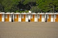 Row of colourful beach huts on a sandy beach Royalty Free Stock Photo