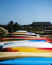 Row of colourful kayaks and paddleboards