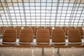 Row of comfortable brown seats for waiting in airport for background