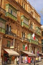 A row of commercial souvenir gift shop shops selling souvenirs with Maltese flags at Melita Street St, Valletta, Malta