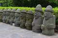 A row of commonly seen Dol hareubangs rock statues in Jeju Island, southern tip of South Korea