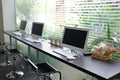 Row of computers waiting for people use at internet cafe