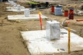 Row of concrete footings for steel columns at the construction site of a new industrial building Royalty Free Stock Photo