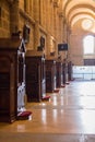 Row of confessional in catholic cathedral in soft light and unfocused. Empty wooden condessional. Church interior. Place for pray. Royalty Free Stock Photo