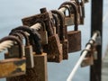 Row of corroded, rusty love locks / padlocks attached to bridge in Portugal.