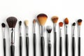 A row of cosmetic brushes with black handles. Cosmetologist tools for makeup