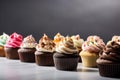row of cupcakes, each topped with unique and unexpected flavor combination