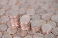 A row of declining dollar coins on a lot of dollars background Royalty Free Stock Photo