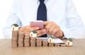 A row of declining dollar coins and a person using a mobile phone Royalty Free Stock Photo