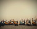 Row of decorative boats on a misty seashore Royalty Free Stock Photo