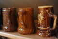 A row of decorative colorful ceramic beer mugs making a collection